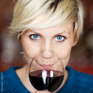 Eine Frau am Wein degustieren